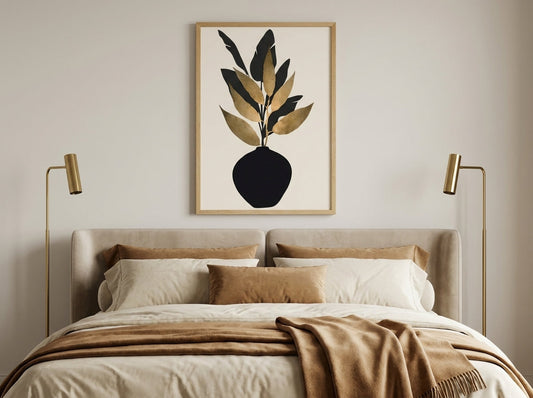 Black and gold botanical print in a natural oak frame above a bed in a quiet luxury bedroom