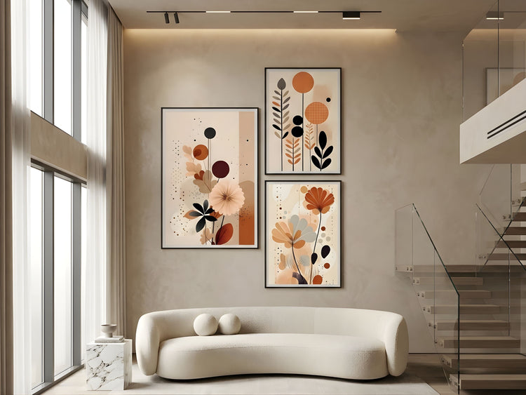 Gallery wall set of three abstract botanical prints in black frames, fully displayed above a sofa in a luxury living room by VYLOIRE