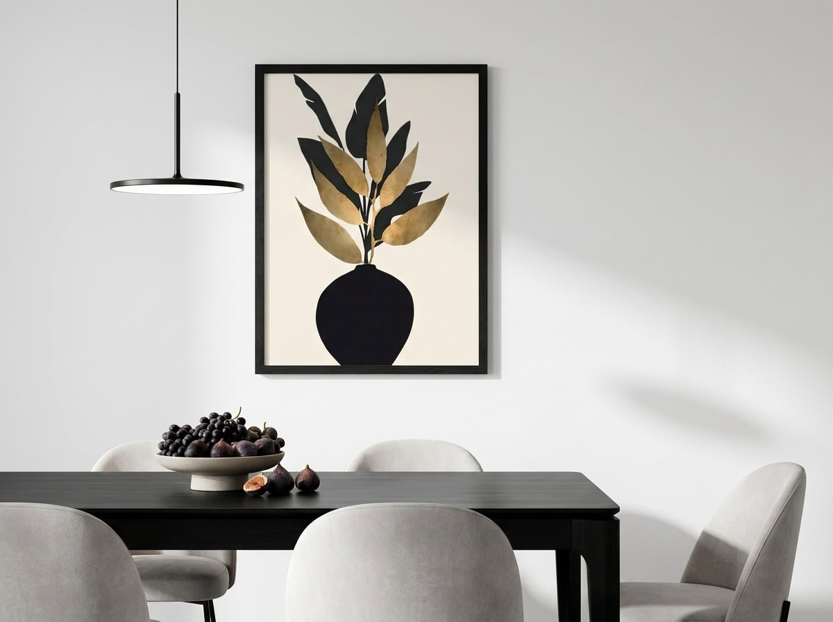 Black and gold botanical vase art print by Vyloire in Black Premium Oak frame, displayed in a minimalist dining room with statement pendant lighting