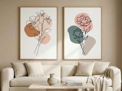 Modern botanical line-art wall art set of 2 in terracotta, sage and blush, oak frames, above a cream sofa in a minimalist living room by VYLOIRE