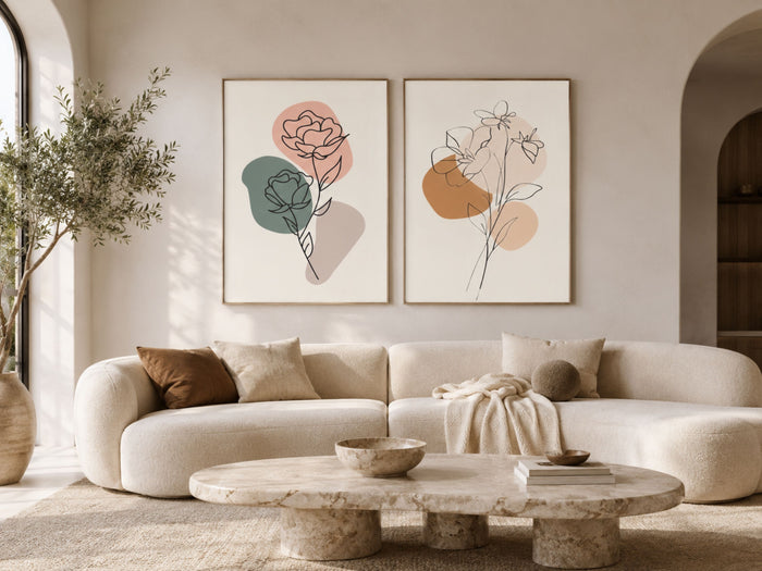 Modern minimalist botanical line-art set of 2 in terracotta and sage, oak frames, above a curved sofa in a luxury living room by VYLOIRE
