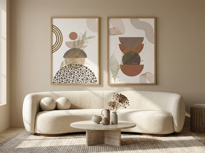 Set of 2 terracotta, rust and sage abstract botanical prints in natural oak frames over a curved bouclé sofa by VYLOIRE.