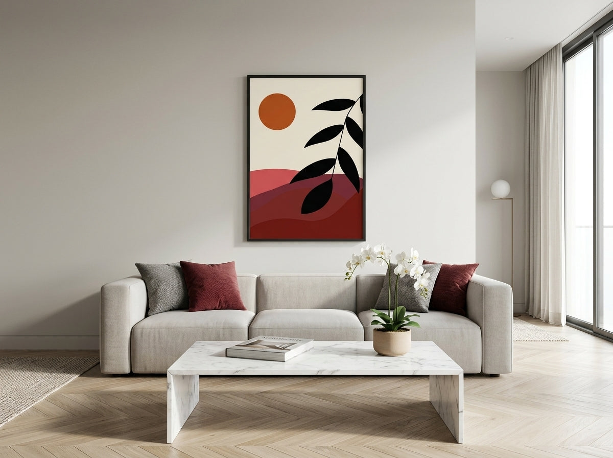 Single abstract sun and landscape art print in terracotta and burnt orange, black frame, above a sofa in a modern living room by VYLOIRE